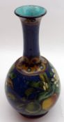 A Doulton Lambeth Faience Vase, decorated by Mary Arding with various fruit and foliage on a blue