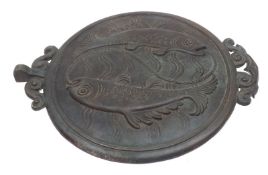An Oriental Bronze Circular Plaque, embossed with swimming fish, applied at either side with