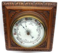 A late 19th Century Oak Cased Aneroid Barometer, carved square case to a spun bras bezel to a 5”