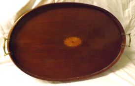 An Edwardian Mahogany Oval Tray inlaid in the centre with a Sheraton style foliate motif and applied