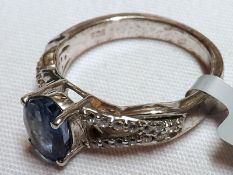 A white metal centre Kyanite Ring with white Zircon set pierced shoulders, stamped “.925”