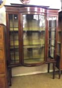 An Edwardian Mahogany Display Cabinet with short pediment and bowed centre, the whole inlaid with