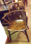 An early 19th Century Windsor type Armchair, the swept yew stick back to an elm seat, front turned