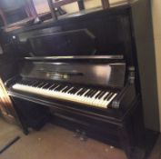 A late 19th/early 20th Century Upright Ebonised Cased Overstrung Piano, F Adam of Krefeld, 55” wide