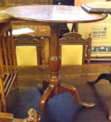 A 19th Century Oak Circular Snap Top Table, raised on a turned pedestal to a spreading tripod