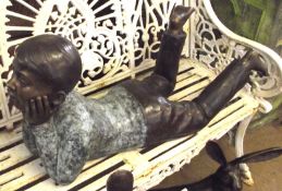 A 20th Century Patinated Bronze Model of a recumbent young boy, 33” long