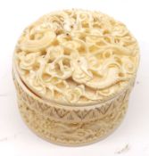 An early 20th Century Oriental Carved Ivory Box with pull-off cover, the surround carved with