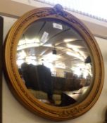 A Circular Gilt and Gesso Framed Convex Wall Mirror, moulded with foliage and ribbon twists, 16 ¼”