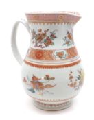 An Oriental Satsuma Jug with grooved handle, predominantly painted in iron red with panels of