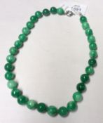 A Jadeite type Bead Necklace, 43cm long, 12mm diameter beads