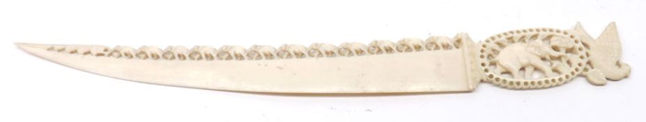 An early 20th Century Carved Ivory or Bone Paperknife, the handle carved with an exotic bird and