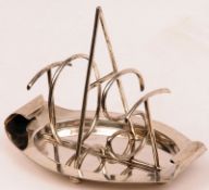 An interesting late Victorian Toast Rack, the oval dish-shaped base with curled side handles, the