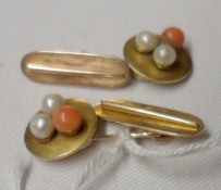 A pair of early 20th Century yellow metal Cufflinks, featuring two Seed Pearls and a Coral stone