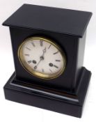A late 19th Century Black Slate Mantel Clock, the plinth-shaped case to a cast brass bezel enclosing