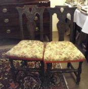 A set of six late Victorian Oak Dining Chairs with Gothic carved detail and floral upholstered