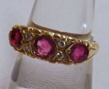 An early/mid-20th Century high grade precious metal Ring, set with three Pale Red Stones and four