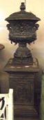 A large reproduction Iron Garden Urn and Pedestal in the classical manner, the urn decorated with