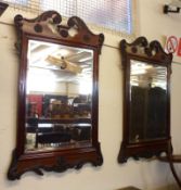 A pair of decorative Mahogany Framed Wall Mirrors, each with swan neck pediments, moulded with