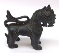 A Chinese Bronze Temple Dog with coiled tail, 18th/19th Century, 4” high