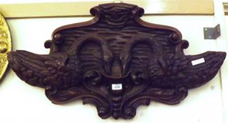 A large Carved Oak Plaque, formed as two swans, the central bowl also decorated with “C” scrolls