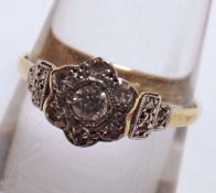 An early 20th Century high grade yellow metal Ring, all small Diamond set and featuring a flower