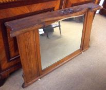 A late 19th Century Oak Framed Bevelled Overmantel Mirror, decorated with inlaid panels in the Art