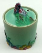 A Clarice Cliff “My Garden” Cylindrical Covered Preserve Pot, plain green glaze body and the lid and