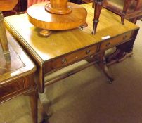 A reproduction Mahogany Sofa Table in the Georgian style, top with two short drop leaves, two frieze