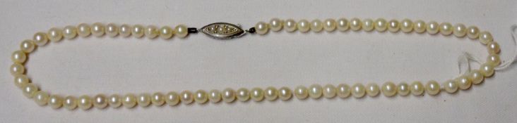 A Strand of Uniform Cultured Pearls with white metal pearl set clasp, 36mm long