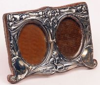 An Art Nouveau Double Photograph Frame of shaped rectangular form, having stylised floral and scroll