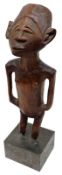 A West African Hardwood Carved Figure, mounted on later square metal base, 8 ½” high