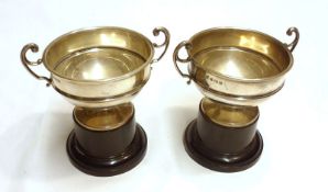 A near pair of early 20th Century Double-Handled Trophy Cups of squat form with spreading circular