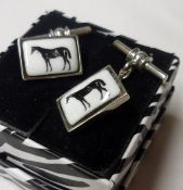 A pair of white metal and Enamelled Cufflinks, the rectangular panels featuring race horses, 17mm