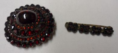 A Victorian all Garnet Set Oval Brooch with raised centre, 38mm x 36mm; together with a small Garnet
