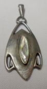 An Art Nouveau period hallmarked Silver Pendant of stylised form, shaped oval with pierced geometric