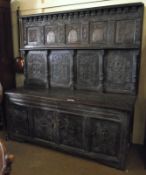 A large Oak Side Cabinet, with nine panelled back with inlaid and carved detail, to a four door