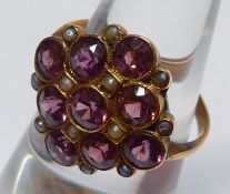 A yellow metal Dress Ring, set with a large diamond-shaped panel featuring nine Amethysts