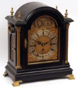 A late 19th Century Ebonised Musical Bracket Clock, the arched cased set with four cast finials over