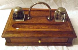 A late 19th/early 20th Century Oak Inkstand of rectangular form, the top with central silver