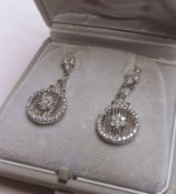 A pair of white metal all White Sapphire Drop Earrings with pierced circular panels, 29mm drop,