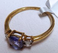 A yellow metal centre square Tanzanite and two small Diamond Ring, stamped “9K”