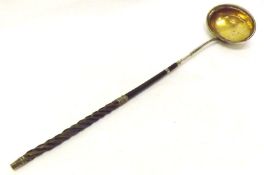 A George III Ladle, with gilt lined bowl on whale twist handle, makers marks rubbed, 15” long