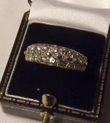 An unmarked yellow metal Ring set with two bands of small Brilliant Cut Diamonds