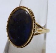 An unmarked yellow metal Iridescent Blue Stone Dress Ring with pierced setting
