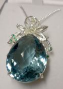 A large white metal framed Aquamarine Pendant, teardrop shaped with foliate hanger, the aquamarine