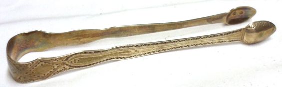A George III Sugar Tongs with bright cut decoration, 5 ½” long