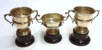 A group of three small early 20th Century Trophy Cups of typical double-handled form, on spreading