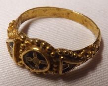 An Antique Gold Mourning Ring with partial Black Enamel detail to a circular panel and two smaller