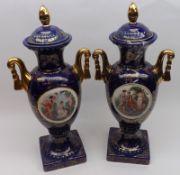 A pair of 20th Century Continental double-handled Lidded Vases, decorated with central panels of
