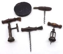 A collection of four assorted wooden handled Vintage Corkscrews, three fitted with brushes; together